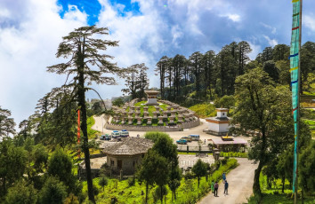 The 108 red and white chortens of Druk Wangyal Khangzang are located on a hillock on the Dochula Pass between Thimphu and Punakha. They were built to honor the Bhutanese soldiers who sacrificed their lives in a battle against insurgents in 2003 © Ipek Morel Diplikaya