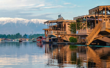 Visitors who live on the houseboats on Lake Dal are transported around the lake on small wooden vessels called shikaras - Photo By Akarat Phasura