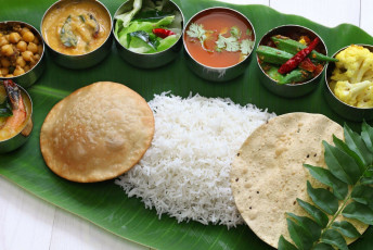 The vegetarian cuisine of Kerala served on banana leaves in the traditional way © bonchan