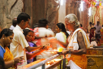 Devotees at the Meenakshi Amman Temple in Madurai, India seek blessings from the priest © Arpad Benedek