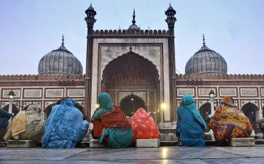 A view of Jama Masjid at dusk wherein Muslim women perform prayer together in Delhi, India © sabirmallick