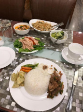A simple but nutritious traditional family meal with rice, soup, vegetables, stir-fried noodles, beef and a salad, Thimphu, Bhutan