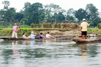 Tourists in dugout canoes on the Rapti River after a visit to the facilities of the Gharial Conservation Program in the Chitwan Park’s buffer zone. These crocodiles were nearing extinction but a program, started in 1978 have bolstered their numbers considerably. © rweisswald