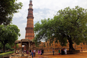 A wonderful view of Qutub-Minar Complex surrounded by trees. It is a 73 metre high tower of victory, built in 1193 by Qutab-ud-din Aibak in Delhi, India © Gritsana P