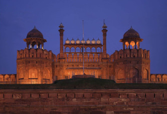A lighted view of the Red Fort also known as Lal Qila is located on the banks of the River Yamuna. The Red sandstone walls of the massive Red Fort rise 33 metre above the clamour of Old Delhi, India © Angelo Giampiccolo
