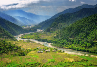 Beautiful scenery of the Punakha Valley covered in rice fields and densely forested hills with breath taking views of the mountains. Bhutan has been described as an earthly paradise especially for lovers of nature © Maurice Brand
