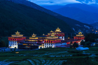 Night scene of the Trashi Chhu Dzong in Thimphu with paddy fields in the foreground. Dzongs are fortified monasteries, usually massive in scale and with high exterior walls © Jiali Chen