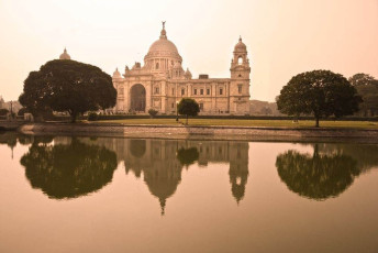 A grand sight of Victoria Memorial which casts its reflection on the pond in front of it, situated in Kolkata, India. © masterlu