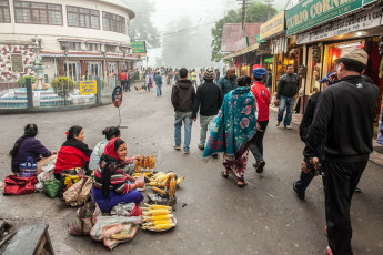 A foggy view of the main market in Darjeeling wherein a woman sells her grilled corn at the crowded street side of the city, India. © Sihasakprachum