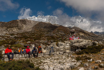 Trekkers take a short break to admire the beautiful landscape on their way from Dingboche to Lobuche on the popular Everest Base Camp trail © mkitina4