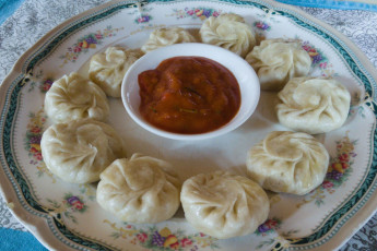 A dish of traditional momos with a dipping sauce served to trekkers on their way to the Everest Base Camp. Momos are steamed dumplings filled with vegetables or meat © Doctor_J