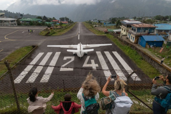A small airplane ready to depart form Lukla Airport. The airstrip is short and steep, and has been called one of the most dangerous airports in the world. This is the starting point for trekkers on the trail to the Everest Base Camp © SPmemory