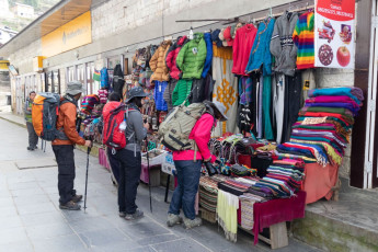 Trekkers looking at the merchandise in a market store in Namche Bazaar before continuing on the trail to Everest Base Camp. Namche is the main trade center for the Khumbu region © SPmemory