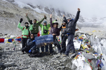 Trekkers celebrating their arrival at the famous Everest Base Camp. There are two base camps at Everest, the southern camp in Nepal and the other in Tibet © kaetana_istock