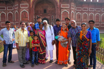 The red sandstone walls of the Jahangiri Mahal in Agra Fort in Agra provide a backdrop for this family portrait. © Don Mammoser / Shutterstock
