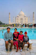 A visiting family take a rest in front of the Taj Mahal in Agra, India. Princess Diana was once famously pictured sitting on this bench. Taj Mahal received UNESCO World Heritage Site designation in 1983 © Don Mammoser / Shutterstock