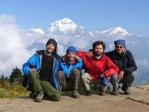 Happy hikers smile at the camera on Poon Hill in the Dhaulagiri Range. It is a.  favorite sunrise lookout spot for trekkers as the views of the Annapurna Mountains are especially beautiful from here © Radim Štrobl