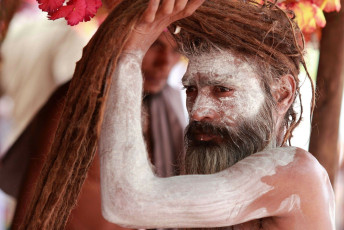 A Naga Sadhu gets ready for the religious festival Kumbh Mela. The Kumbh Mela at Prayag attracts millions of pilgrims from all around the world, Prayag, India © AJP