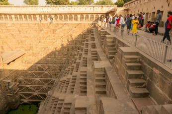 Tourists admire the ancient Chand Baori in Abhaneri, Rajasthan. One of the deepest and largest stepwells used for water storage in the world, it reaches 13 stories down and has a temple at the back, as well as a palace which was added later © Amlan Mathur