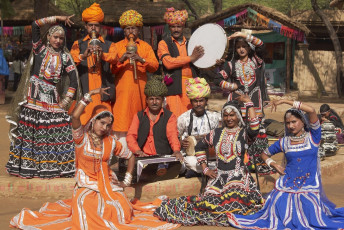 A group of Tribal dancers and musicians dressed in their traditional colorful costumes at Dilli Haat, New Delhi, India © JeremyRichards