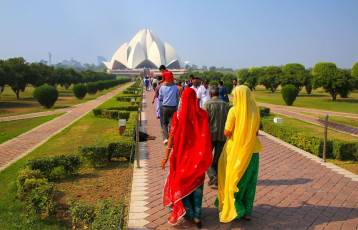 Afar view of the Lotus Temple wherein the visitors walk towards it. The temple is built in the shape of a lotus flower and is the last of seven Major Bahai's temples in Delhi, India © Don Mamosser