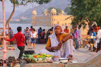 An old Indian Woman sitting at the bank of Man- Sagar Lake, sells a variety of street food to the day trippers, Jaipur, Rajasthan, India. © Don Mammoser
