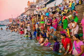 The ancient ghats on the Ganges in Varanasi are adorned with color as people in traditional clothing perform their Hindu rituals and bathe in the river - Photo by CherylRamalho