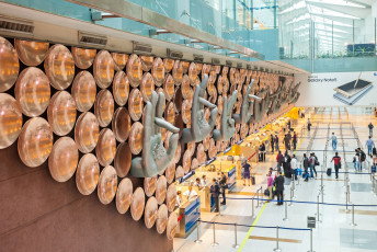 The Indira Gandhi International Airport in Delhi is one of the busiest passenger airports in the world. Buddhism mudras, symbolic hand gestures that bring joy and happiness decorate the wall, India © saiko3p
