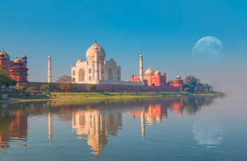 The famous Taj Mahal, the marble mausoleum, is beautifully reflected in the Yamuna River at sunset, Agra, India © muratart