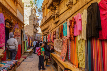 A colorful alley lined with stores inside Sonar Fort in Jaisalmer. The fort is also referred to as the Golden Fortress due to its yellow sandstone that turns a golden honey color in the setting sun