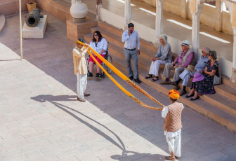 Tourists watch as a guide instructs them on the art of turban wrapping at the museum at Fort Mehrangarh, Rajasthan. Anything between 9.8 to 19.7 ft./3 to 6 m of fabric is used for a turban