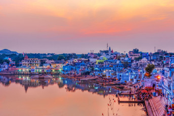 The setting sun paints Pushkar Lake and the town in beautiful soft colors. Hindu worshippers flock to the ghats to bathe in the sacred waters, believed to wash away sins