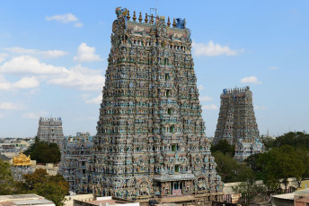 Gopurams, or high towers, at the Madurai’s Meenakshi Sundareshwar Temple looking over the arcade