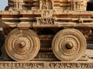 A pair of elaborately carved stone chariot wheels at the Vittala Temple Complex in Hampi.