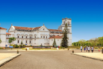 Devotees walk towards a convent in Goa with unique Portuguese architectural influence, much like other aspects of Goan culture such as food, religion, and more.