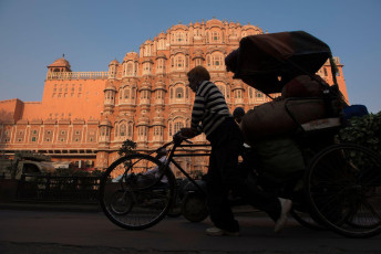 The unique Hawa Mahal, or Palace of the Winds, in Jaipur, Rajashtan provides a fitting backdrop for the shadow of a rickshaw driver carrying his wares to market. © arun sambhu mishra / Shutterstock