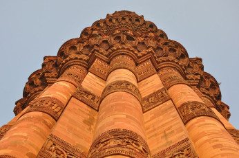 A beautiful upward view of the Qutub Minar which has paintings carved on it, also known as the "victory tower" in Delhi, India © Ritu Manoj Jethani