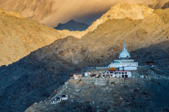 A beautiful distant view of Shanti stupa which is a Buddhist white-domed stupa on a hilltop in Chanspa near Leh, Ladakh, India © theskaman306