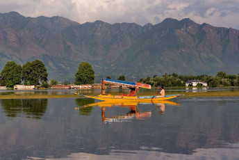 A glimpse of the lifestyle on Dal Lake where the locals use Shikara which are small boats for lake transport in Srinagar, Jammu and Kashmir State, India © khlongwangchao