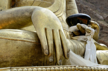 A bottom view of the old golden Buddha statue in the Tibetan Hemis Monastery in Ladakh, India. It is known to be one of the wealthiest Tibetan Monasteries © eAlisa