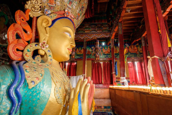 A grand colorful view of the Maitreya Buddha statue at Thiksey Monastery which is famous for its 49 ft tall statue in the lotus position, Leh-Ladakh, India © designbydx