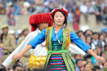 Two Young villagers dressed in traditional Tibetan costumes perform the famous traditional folk dance and songs of different parts of Ladakh on the last day of the annual Ladakh Heritage Festival in Leh, India © eAlisa