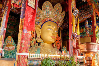 A majestic golden statue of Maitreya Buddha located at Thiksey Monastery in Leh-Ladakh. It is a Tibetan Buddhist monastery with an active monk community, India © Designbydx