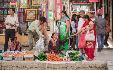 Two local women sell fruits and vegetables on the streets of a congested market in Leh Ladakh, India © Nuk2013