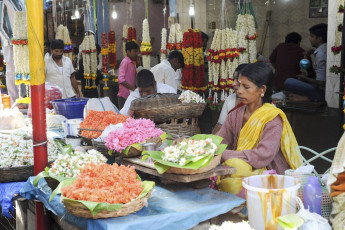A long lane of Indian florists sell fresh flowers and garlands to the customers at the Devaraja market, located in the city of Mysore, Karnataka, India © fotoember