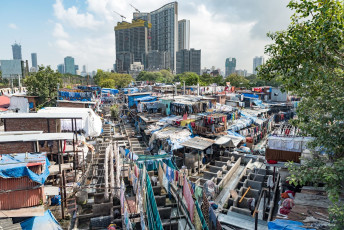 Washing lines extend across the walkway at the Dhobi Ghat in Mumbai. It is a huge open-air laundry where dhobis or washer men clean linen and clothes from hotels and hospitals in the city © Steven Sullivan
