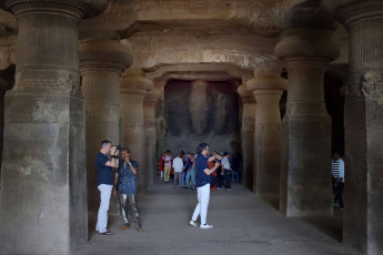 Tourists in the passageway leading to the three-headed depiction of Shiva, the Trimurti at the Elephanta Cave Temples in Mumbai Harbor © Babua's Photoshoot