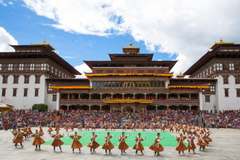 11.	People in their thousands flock from far and wide to witness the colorful Masked Dance Festival in the huge courtyard of the Thimphu Dzong, Bhutan. The Tshechu Festival celebrate the good deeds of Guru Rinpoche through traditional songs and dances by men and women dressed in colorful outfits © Sammy L