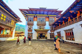 Foreign visitors in the beautiful courtyard of the Punakhu Dzong, Bhutan. This monastic fortress is regarded as the most majestic in the kingdom and is a six-story high structure located between the Mo Chhu and Po Chhu rivers © rabbito