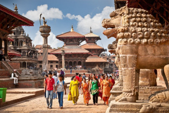 Dense crowds in Durbar Square where people explore the surrounding area. At the same time, the Newari architecture of the lions makes the sight even more scenic in Lalitpur City Patan, one of the Three Imperial Cities in Kathmandu Valley, Nepal © Alexsandar Todorovic